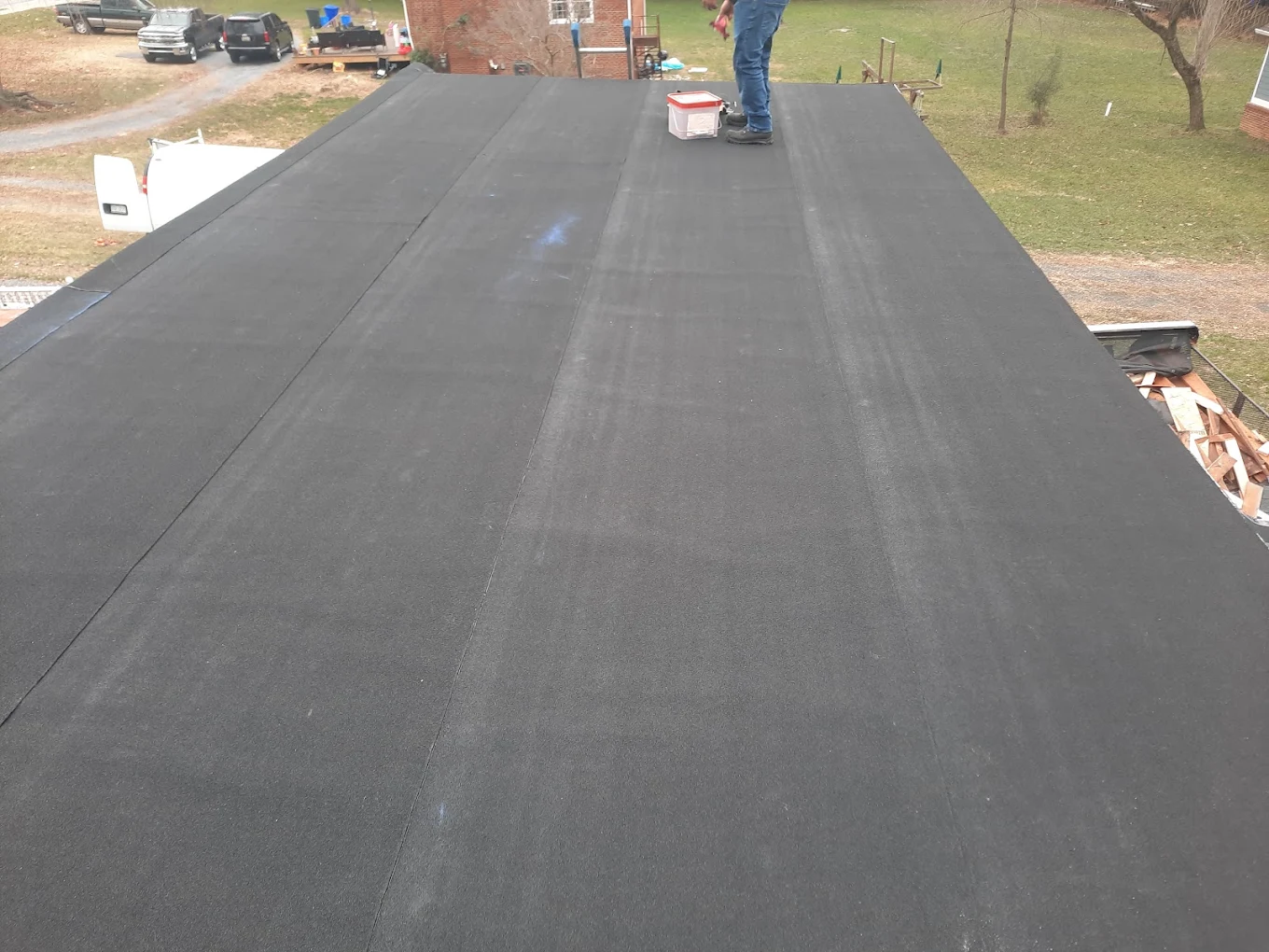 Black rubber membrane flat roof installation in progress by J Castillo Construction near Herndon, VA