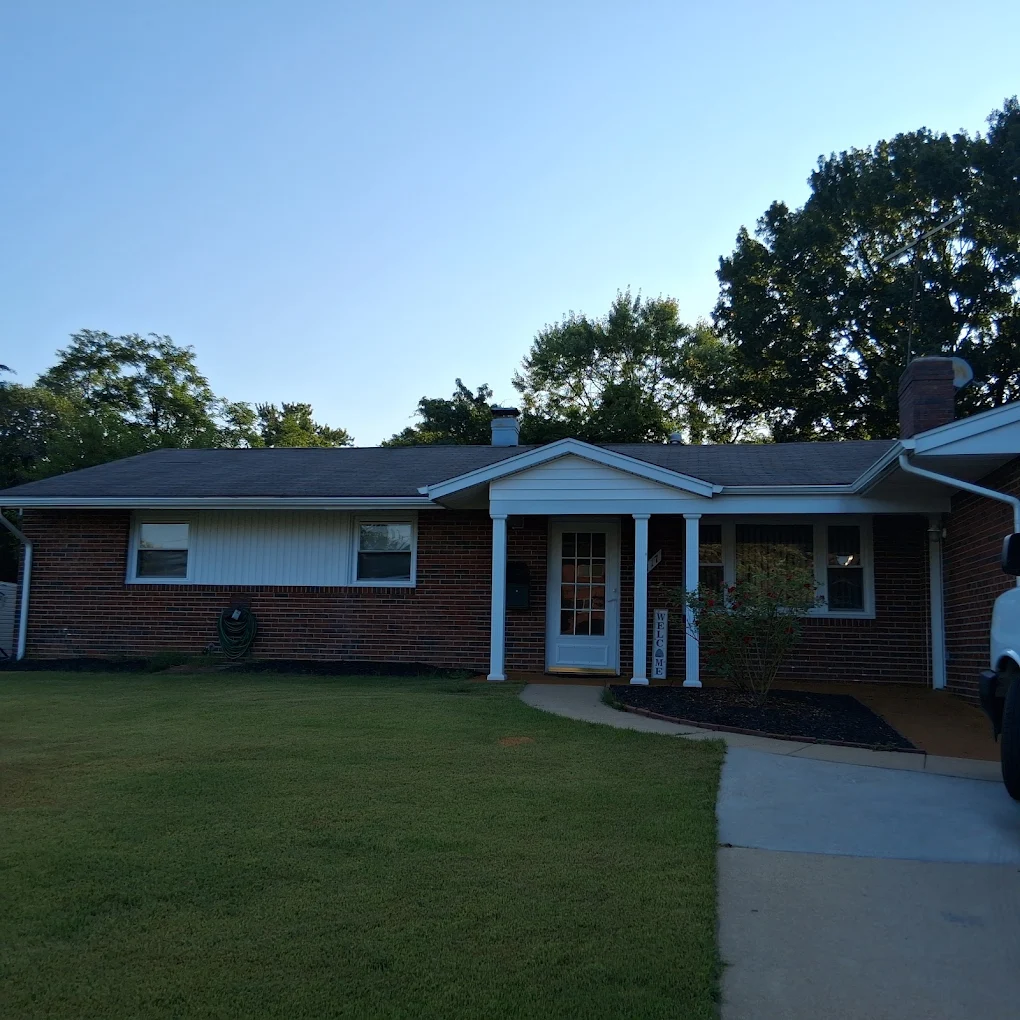 Residential home with clean gutters and shingle roof by J Castillo Construction