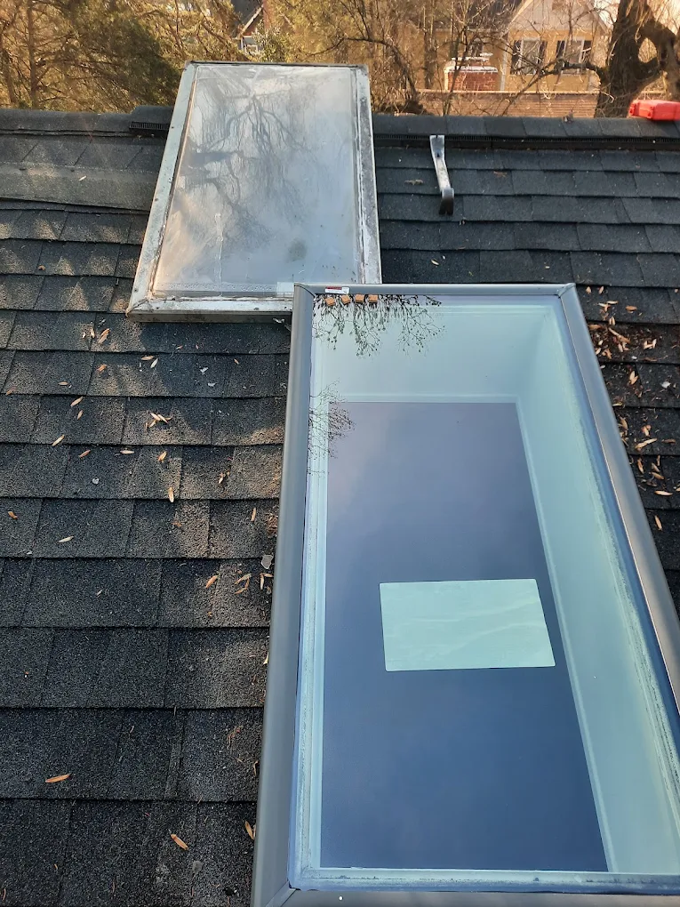 New skylight installed next to an old unit on a shingle roof by J Castillo Construction